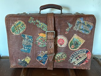 Vintage Leather Luggage Covered In Travel Stickers