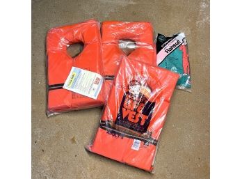 Pile Of New Old Stock Life Vests And Rainsuit