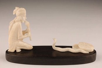 HAND CARVED BONE STATUE OF A SNAKE CHARMER