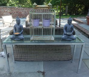 OUTDOOR CHROME GLASS TABLE WITH BIRDCAGE AND PAIR OF BUDDHA STATUE