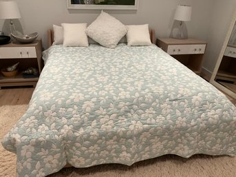 Pretty Blue King Size Quilt With White Flowers And White Throw Pillows