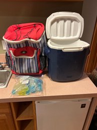 One Backpack And Rolling Cooler One Coleman  Rolling Cooler With 30 Reusable Ice Cubes