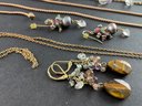 Large Assortment Of Costume Jewelry In Pinks, Greens, And Browns