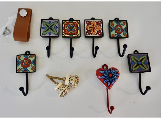Various Colorful Ceramic Wall Hooks And Knobs, As Well As A Leather Drawer Pull