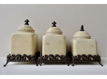 3 Ceramic Canisters With Metal Stands