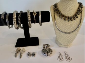 Bracelets, Earrings, And Necklaces In Silver Tones