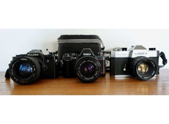 3 Vintage SLR Cameras & 1 Case Including Yashika, Fujica, & Konica