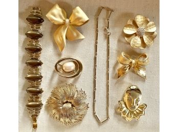 Assorted Gold Toned Brooches, Chain, And Bracelet