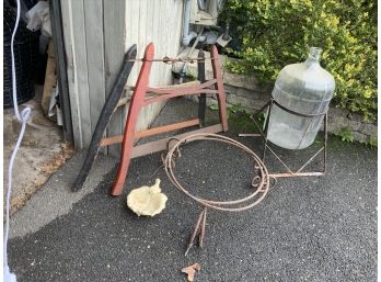 2 ANTIQUE SAWS, BOTTLE IN METAL STAND,  2 STANDS, METAL BIRD