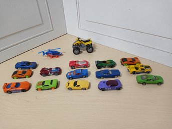 Fourteen Matchbox/hotwheels Style Toy Cars, A Helicopter And A Larger Atv Toy.