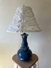 Blue Glass Lamp With Floral Decor And Cinched Shade