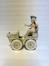 Small Decorative Porcelain Boy Figurine In Car