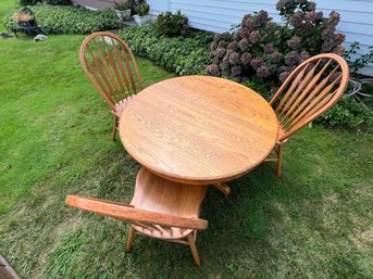 Circular Wooden Table With Three Matching Chairs.