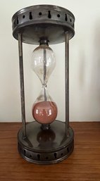 A Vintage Metal Framed Hourglass With Pierced Decoration To Top And Bottom