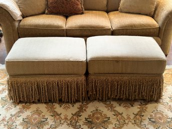 2 Beige Rolling Ottomans With Tassel Bottoms