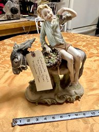 CAPODIMONTE FIGURINE 'BOY ON DONKEY EATING GRAPES'