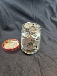 A Jar Filled With Silver Dimes