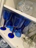 K/ 3 Shelves Of Asstd Glass Drinkware Barware - Variety Of Sizes & Types, Some Clear, Blue, Smokey Gray