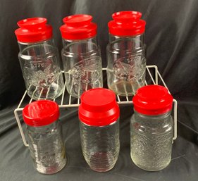 Circa 1970s -90s Embossed Clear Storage Jars With Red Plastic Lids.