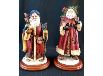 Two Ceramic Santas On Wooden Bases.