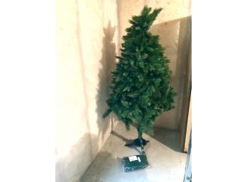 Assembled Christmas Tree And Metal Stand With A Tarp.