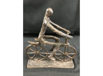 Heavy Metal Sculpture Of Person On Bike
