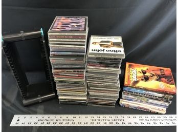 A Lot Of CDs And DVDs With CD Holder