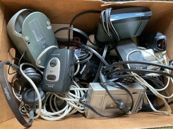 Lot 266- Box Of Mixed Walk Man Radios Cords Remote Controls Etc