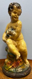 Ceramic Cherub Holding A Dog Statue