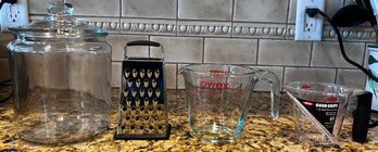 Large Glass Cookie Jar, Stainless Steel Cheese Grater, And 2 Measuring Cups - 4 Piece Lot