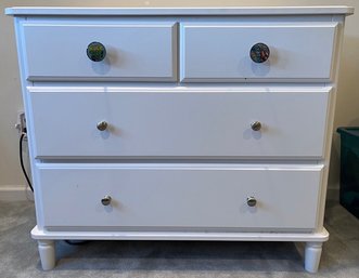 White Four Drawer Dresser With Comic Knobs