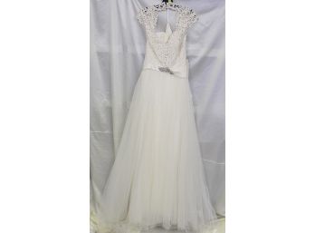 Romance Bridal By Allure Is An  A-Line Gown Complete With Lacy Cap Sleeves & Delightful Keyhole Back