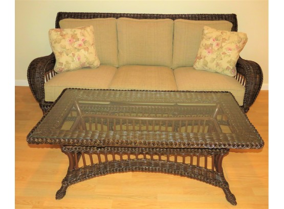 Fabulous Wicker Sofa 2-throw Pillows And Glass Top Coffee Table
