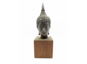 Bronze Head Of Buddha On Wooden Block
