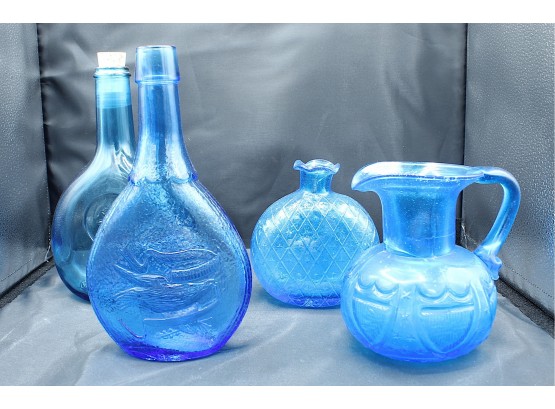 Four Light Blue Glass Bottles; Three Bottles, One Pitcher (037)