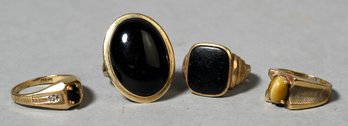 Four 10k Gold Onyx And Tigers Eye Rings (CTF10)