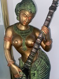 Brass Woman Playing Instrument