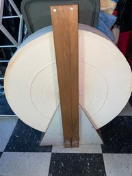 Cheese Wheel Of Toilet Paper On Wood Stand