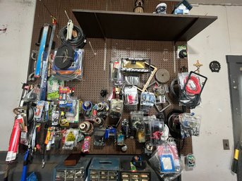 WALL OF VARIOUS AUTO PARTS AND RELATED GEAR
