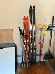 Two Sets Of Skis And Poles