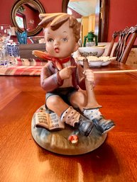 Boy Sitting With Horn Ceramic Figurine