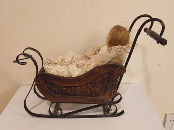 Iron And Wicker Sleigh With Porcelain Doll