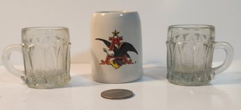 A Miniature Anheizer Bush Mug With Two Victorian Miniature Pattern Glass Mugs