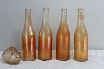 Four Vintage Carnival Bottles And One Carnival Glass Piggy Bank