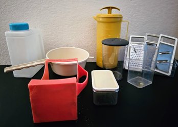 An Assortment Plastic Ware Incl. Pitchers, Grater With Variety Pieces, Strainer And More
