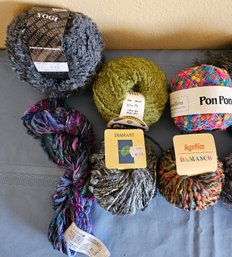 An Assortment Of Specialty Yarn With Various Colors
