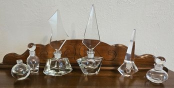 A Collection Of Vintage Clear Glass Decanters With Doily