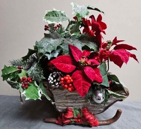 Poinsettia In A Ceramic Christmas Sleigh