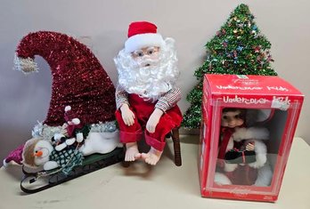 An Assortment Of Holiday Decor Incl. Santa Clause, Tinsel Decor, Undercover Kids Animated Doll And More