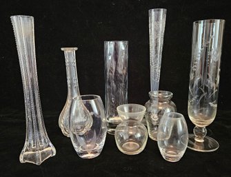 Clear Glass Vases Of Various Shapes And Sizes